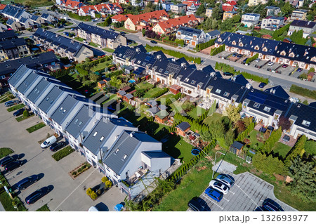 Aerial view of modern residential neighborhood with townhouses and parking areas Aerial view of modern residential neighborhood with townhouses and parking areas 132693977