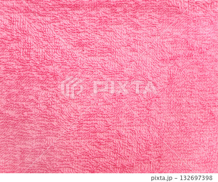 Terry towel or carpet of pink color. Background with fluffy towel terry cloth. Natural cotton fabric texture. Long pile canvas. Close-up of soft cotton terry cloth. Material of domestic cotton rug 132697398
