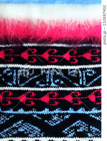 Horizontal or vertical Christmas background with knitted fabric. Wool sweater texture of red, dark blue color with white border. Natural knitted wool material with decorative ornament and furry border Horizontal or vertical Christmas background with knitted fabric. Wool sweater texture of red, dark blue color with white border. Natural knitted wool material with decorative ornament and furry border 132697402