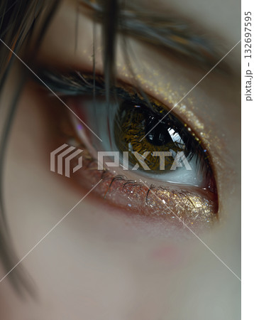 Close-up of a beautiful Korean eye showcasing sparkly makeup and lush eyelashes in soft natural lighting 132697595
