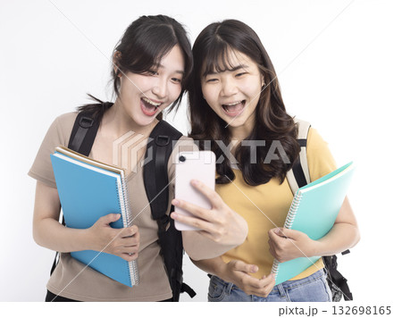 Excited Asian female students watching the smart phone Excited Asian female students watching the smart phone 132698165