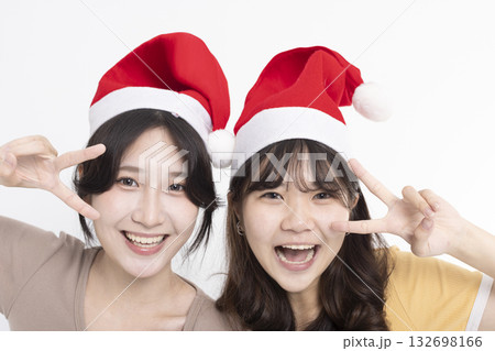 Girls in Santa's caps having fun 132698166