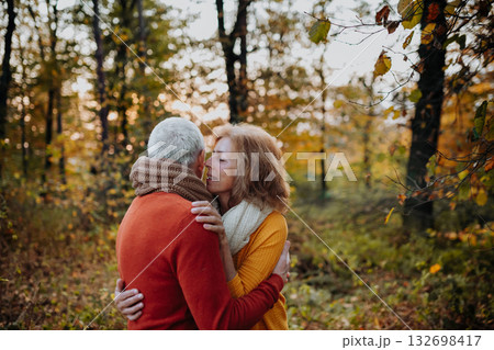 Romantic moment between senior couple, standing in autumn nature. 132698417