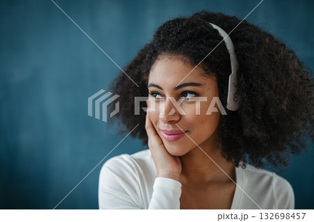 Portrait of young woman with headphones indoors at home, listening to music. Portrait of young woman with headphones indoors at home, listening to music. 132698457