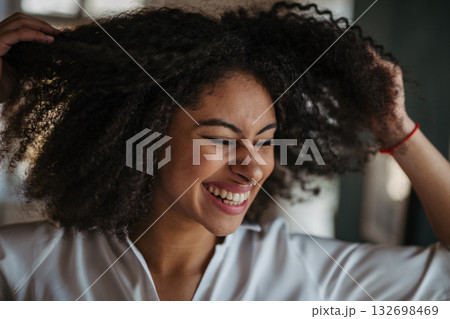 Close-up portrait of beautiful young woman with curly hair. Close-up portrait of beautiful young woman with curly hair. 132698469