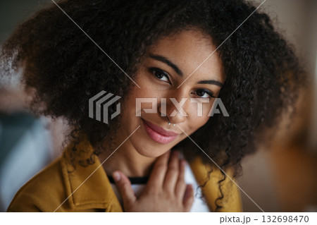 Portrait of beautiful young woman with curly hair. 132698470