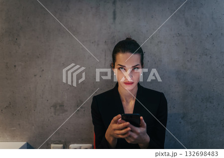 Portrait of young businesswoman reading email on smartphone. Portrait of young businesswoman reading email on smartphone. 132698483
