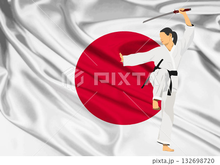 Martial artist performing kata with katana in front of japanese flag 132698720