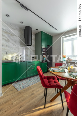 Modern Kitchen Interior with Green Cabinets and Red Velvet Chairs 132700195