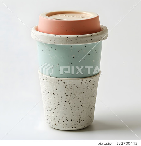Mint and beige reusable travel mug with ribbed silicone sleeve; minimal studio still life for eco lifestyle. 132700443