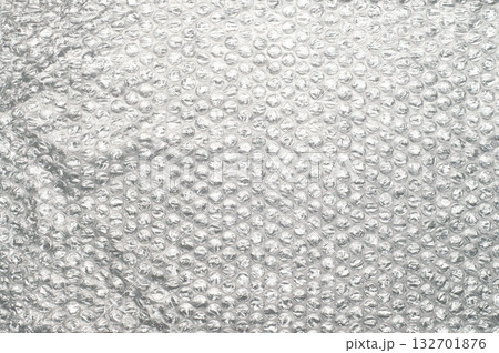 Bubble wrap packaging material with transparent plastic surface and air-filled bubbles, isolated background texture for protection, shipping, storage, moving, and wrapping. 132701876