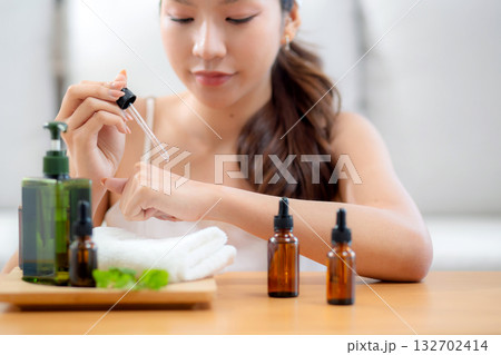Closeup hands young woman cheerful applying skincare or cream herb on hands at home. Closeup hands young woman cheerful applying skincare or cream herb on hands at home. 132702414