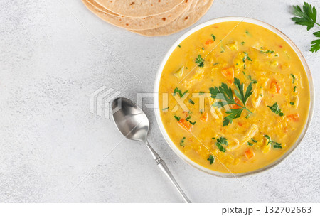 Mulligatawny soup with lentils vegetables with chapati flatbreads on white background. Top view. Copy space. Indian food 132702663