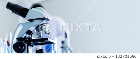 Banner Science microscope equipment in biology chemical laboratory. Scientific experiment Microscope on Lab table microbiology equipment. Banner Chemistry objects on lab background with copy space Banner Science microscope equipment in biology chemical laboratory. Scientific experiment Microscope on Lab table microbiology equipment. Banner Chemistry objects on lab background with copy space 132703060