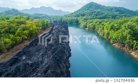 Verdant Forest and Black Earth along Serene River Bank under a Clear Sky Verdant Forest and Black Earth along Serene River Bank under a Clear Sky 132704936