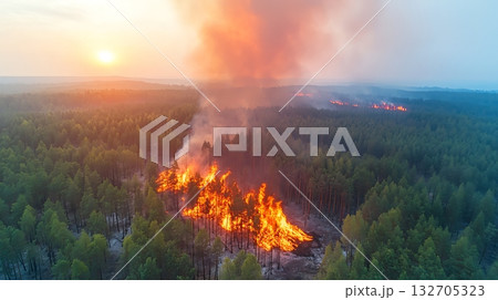 Aerial View of Wildfire Flames and Smoke Rising Over Dense Forest Landscape at Sunset Aerial View of Wildfire Flames and Smoke Rising Over Dense Forest Landscape at Sunset 132705323