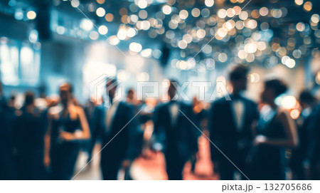 People in formal attire celebrating at a gala event with bright lights and a lively atmosphere People in formal attire celebrating at a gala event with bright lights and a lively atmosphere 132705686