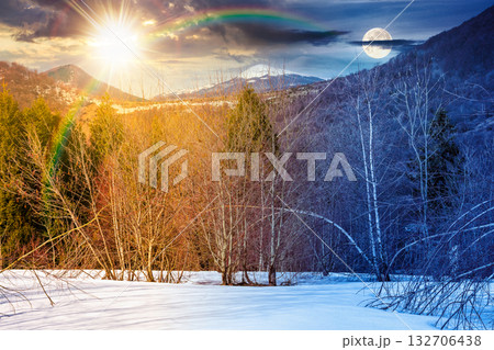mountain landscape with mixed forest on snow covered slope. day and night time change concept. sky with clouds, sun and moon on spring equinox. duality and transition template. naked trees scenery 132706438