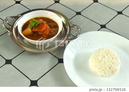 boiled chicken carrot and potato in sweet red gravy sauce stew eat couple plain rice on plate  132706526