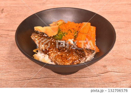 grilled saba fish or mackerel topping crab stick and shrimp egg couple sweet egg on japanese rice in bowl 132706576