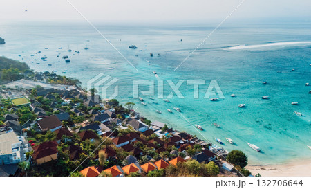 Nusa Lembongan with tropical beach coastline and turquoise ocean with boats, drone view Nusa Lembongan with tropical beach coastline and turquoise ocean with boats, drone view 132706644
