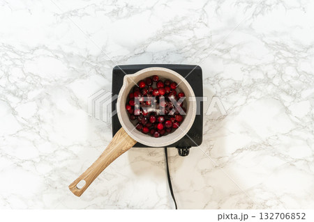 Simmering fresh cranberries to make a flavorful sauce for the cranberry buttercream topping. Simmering fresh cranberries to make a flavorful sauce for the cranberry buttercream topping. 132706852