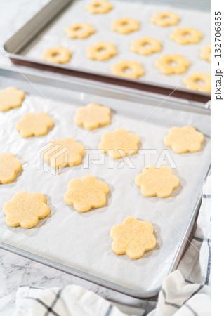 Alternating layers of top and bottom flower sugar cookies prepared for Easter Cookie Sandwich with Raspberry Buttercream. These cookies bake to soft perfection. 132706855