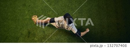 Baseball pitcher top view completing powerful throw Baseball pitcher top view completing powerful throw 132707408