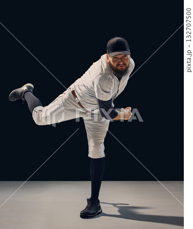 Baseball pitcher finishing throw showing full-body balance and technique. 132707500