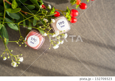 Top view of TPO free gel nail polish lying on a table in soft natural light. Highlighting clean beauty choices and awareness of Trimethylbenzoyl Diphenylphosphine Oxide in cosmetics 132709323