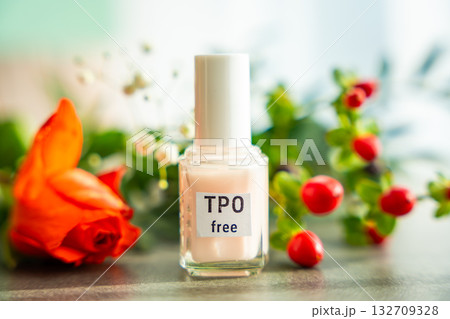 TPO free gel nail polish lying on a table in soft natural light. Highlighting clean beauty choices and awareness of Trimethylbenzoyl Diphenylphosphine Oxide in cosmetics 132709328