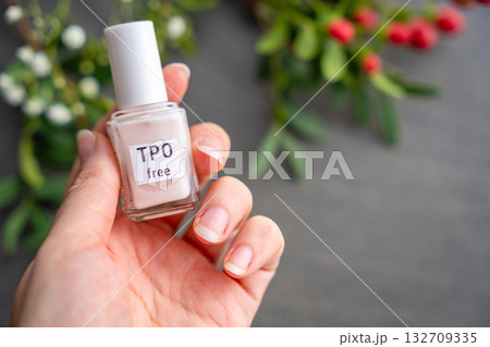 TPO free gel nail polish lying on a table in soft natural light. Highlighting clean beauty choices and awareness of Trimethylbenzoyl Diphenylphosphine Oxide in cosmetics TPO free gel nail polish lying on a table in soft natural light. Highlighting clean beauty choices and awareness of Trimethylbenzoyl Diphenylphosphine Oxide in cosmetics 132709335