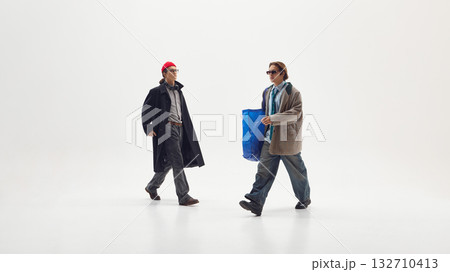 Two men in business casual streetwear walking confidently expressing creativity and teamwork 132710413