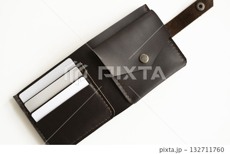 Opened handmade brown leather wallet with a blank cards inside on marble surface 132711760