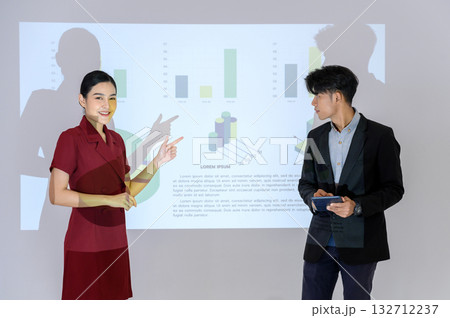 Business man and woman gives presentation to colleagues during meeting, Shows Infographics Animation on Big Screen. 132712237