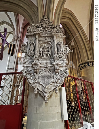 This photo shows a lavish baroque stone memorial inside a cathedral in Osnabruk, covered with intricate carvings, statues, and Latin inscriptions. 132712561