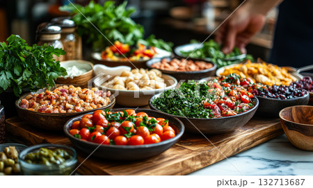 Table full of food with a variety of dishes including salads, vegetables 132713687