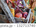 Wooden crate filled with fall fruits and vegetables, including apples 132713740