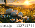 Group of four eggs are laying in a field of flowers 132713744