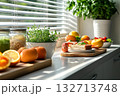 Kitchen counter with a variety of fruits and vegetables, including oranges 132713748