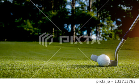 Golf clubs and balls on a green lawn in a beautiful golf course with morning sunshine. 132713765