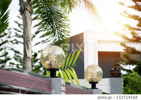 Decorative lamps on the top of the fence posts 132714588