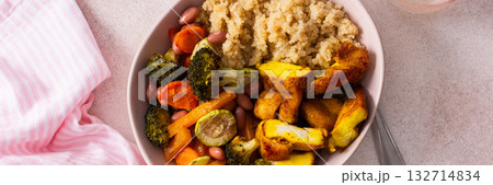 A nutritious breakfast showcases a bowl of quinoa accompanied by vibrant baked sweet potatoes, carrots, zucchini, beans, and turmeric chicken, paired with a fresh salad on the side, banner A nutritious breakfast showcases a bowl of quinoa accompanied by vibrant baked sweet potatoes, carrots, zucchini, beans, and turmeric chicken, paired with a fresh salad on the side, banner 132714834