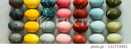 A beautiful array of hand-dyed Easter eggs in various colors, neatly arranged in rows. This colorful display celebrates the spring season and Easter traditions with creativity, banner A beautiful array of hand-dyed Easter eggs in various colors, neatly arranged in rows. This colorful display celebrates the spring season and Easter traditions with creativity, banner 132714861