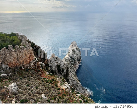 stone wall ruins mountain sea horizon cloudy. High quality photo stone wall ruins mountain sea horizon cloudy. High quality photo 132714956