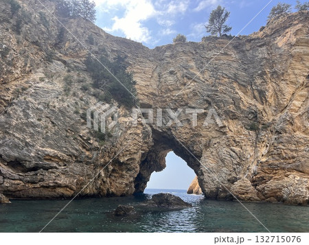 arch in the rock sea calm clear water. High quality photo 132715076