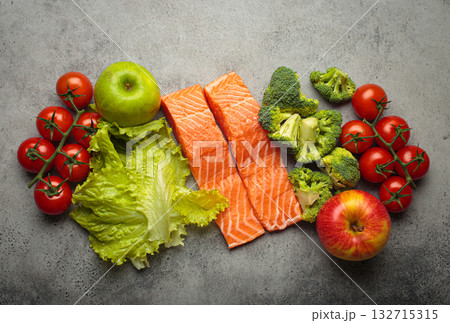 Fresh raw healthy food vegetables fruit salmon fillet grey background, inflammatory diet, clean eating 132715315