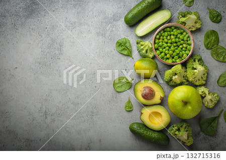 Fresh green vegetables and fruit grey concrete background top view, diet, vegetarian copy space 132715316