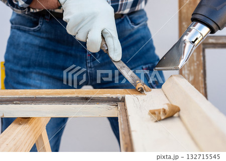 Carpenter at work, restoring an old wooden window. Carpentry. Carpenter at work, restoring an old wooden window. Carpentry. 132715545