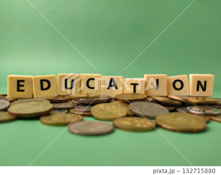 The image shows the word EDUCATION resting on a pile of coins.This visual is often used to represent the financial aspect of education. 132715880